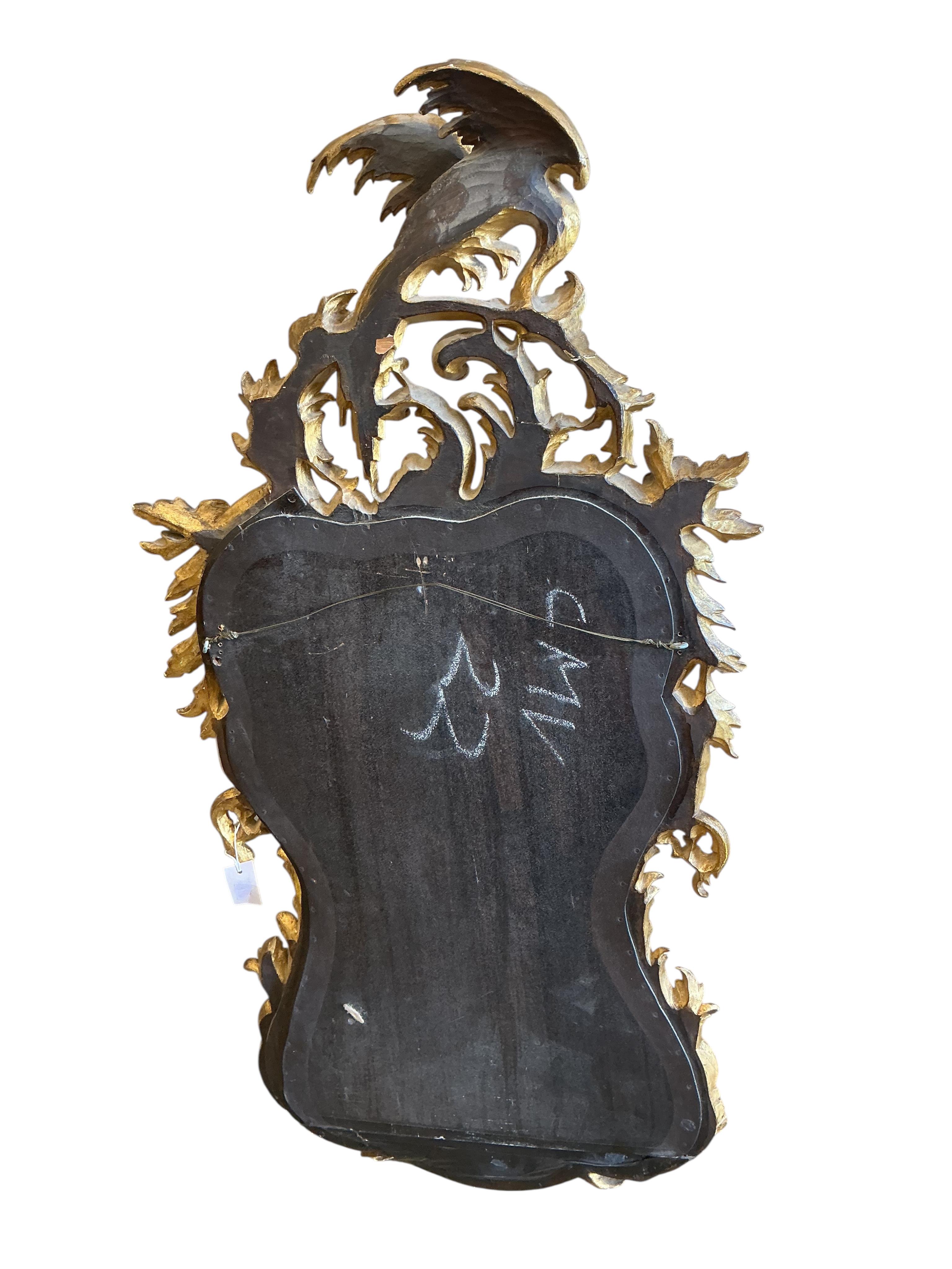 An 18th century style carved giltwood wall mirror, width 64cm, height 128cm